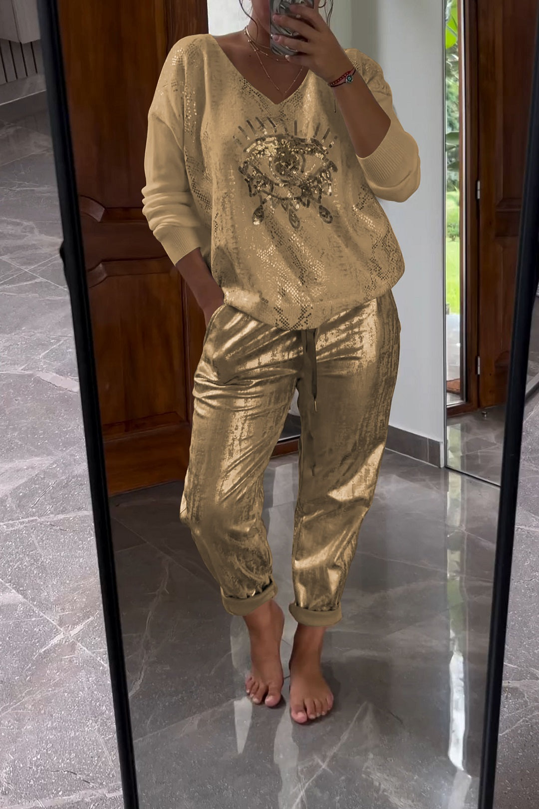 Fashionable two-piece set consisting of a sequin top and bronze-colored trousers